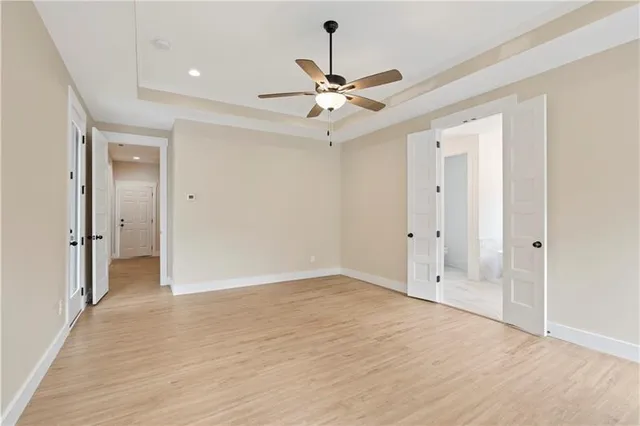 wooden floor in an empty room with a fan
