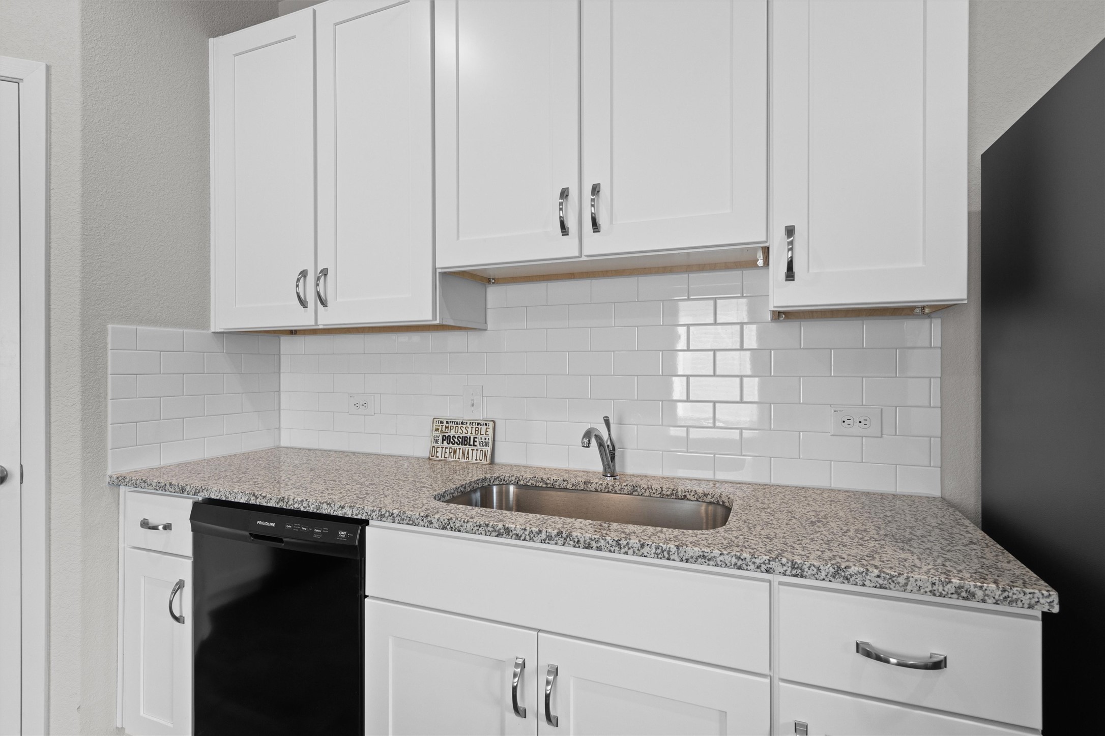 2606 Totley Road Manor, TX 78653 - Photo 8 of 28 a kitchen with white cabinets and a sink
