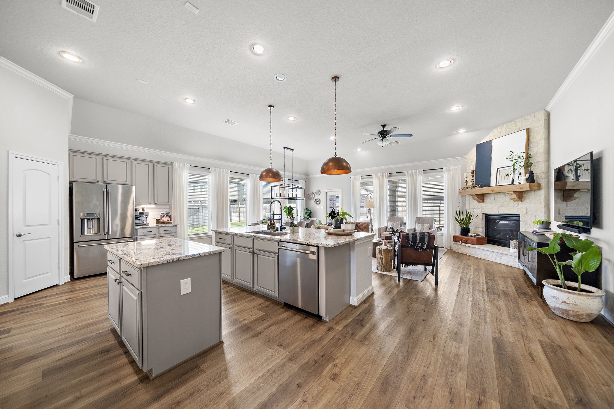 19103 Heather Downs Court Cypress, TX 77429 - Photo 14 of 35 a kitchen with stainless steel appliances granite countertop wooden floors and view living room