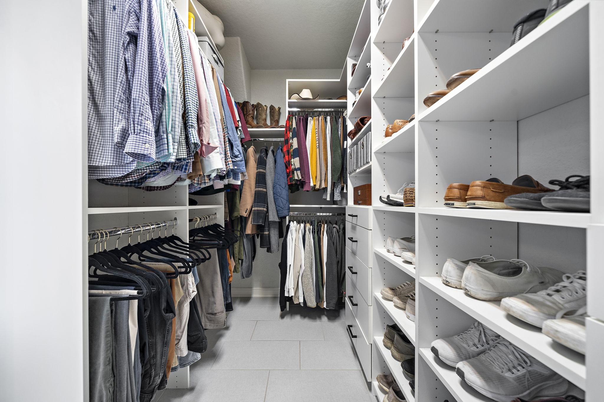 19103 Heather Downs Court Cypress, TX 77429 - Photo 23 of 35 a view of walk in closet with clothes and shoes