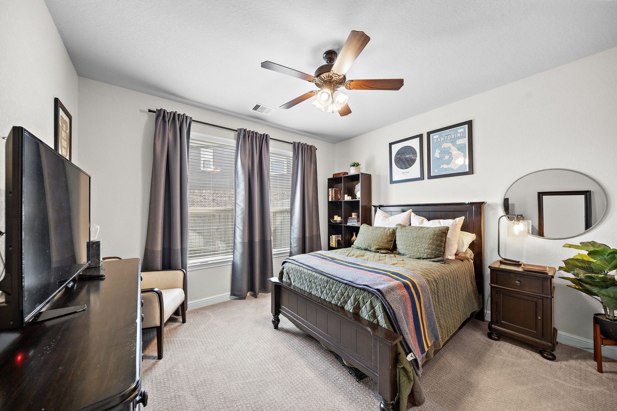 19103 Heather Downs Court Cypress, TX 77429 - Photo 27 of 35 a bedroom with a bed desk and a flat screen tv