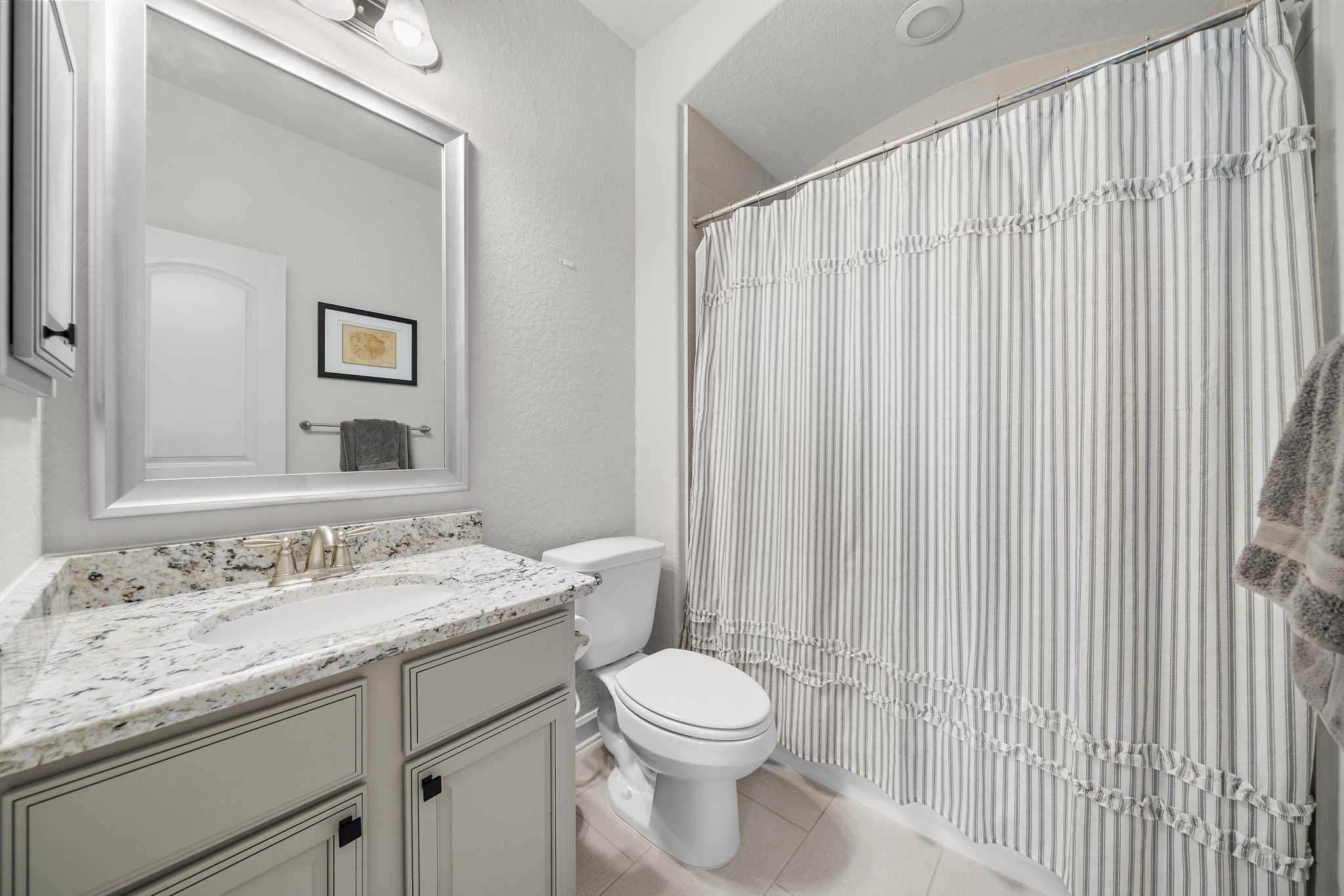 19103 Heather Downs Court Cypress, TX 77429 - Photo 28 of 35 a bathroom with a granite countertop sink vanity mirror and toilet