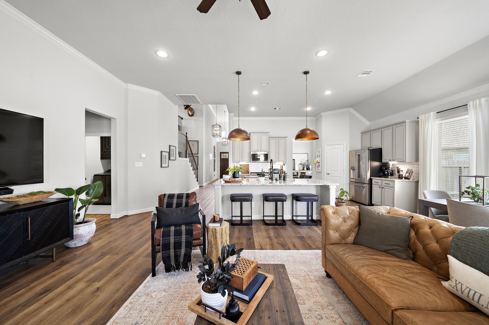 19103 Heather Downs Court Cypress, TX 77429 - Photo 9 of 35 a living room with furniture kitchen view and a flat screen tv