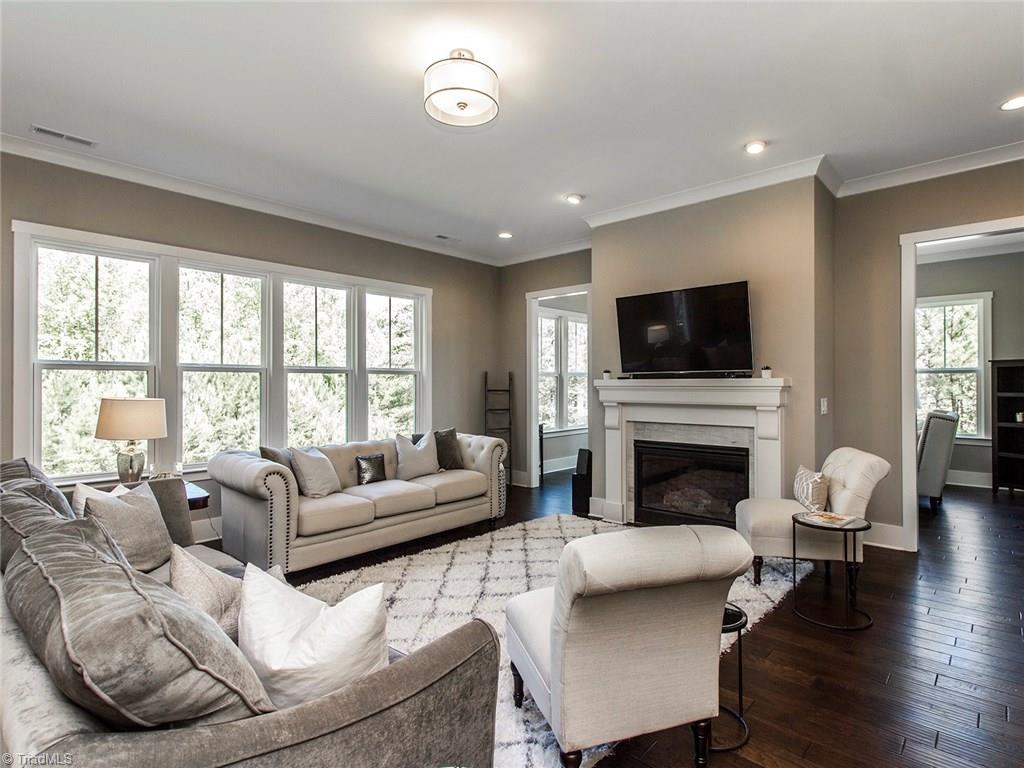6807 Koala Drive Oak Ridge, NC 27310 - Photo 11 of 28 Gorgeous sunroom ideally located behind idyllic anchor fireplace.