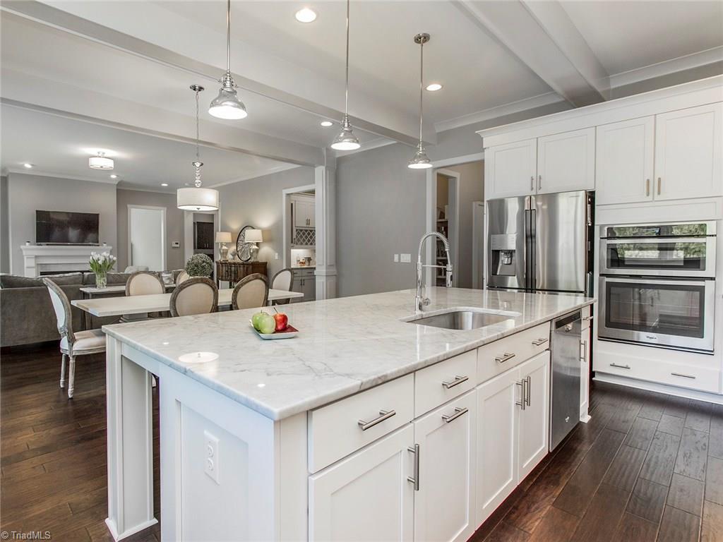 6807 Koala Drive Oak Ridge, NC 27310 - Photo 15 of 28 Completely open main level living with eat in kitchen area, top notch marble counters, and cutting edge stainless steel appliances.