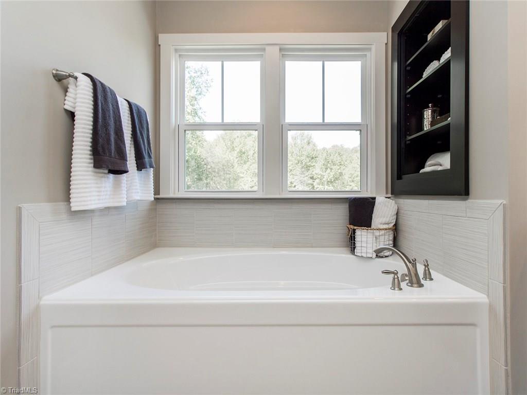 6807 Koala Drive Oak Ridge, NC 27310 - Photo 21 of 28 Master bath tub with it's own set of built ins and private views.
