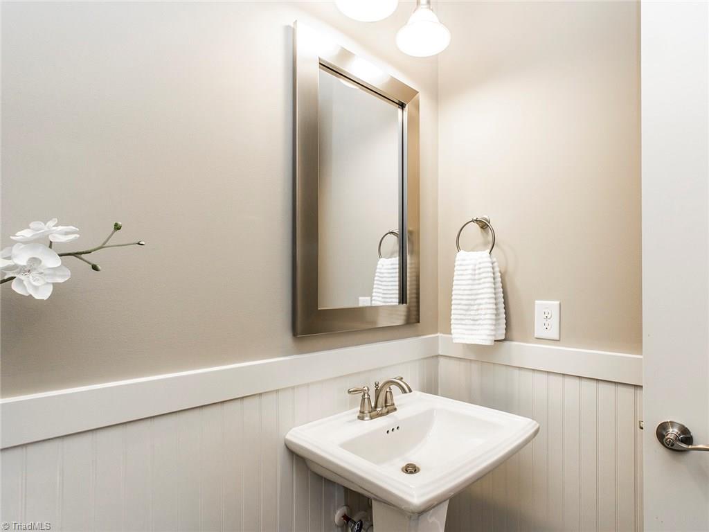 6807 Koala Drive Oak Ridge, NC 27310 - Photo 6 of 28 Heavy chair rail and bead board in warm main level half bathroom.