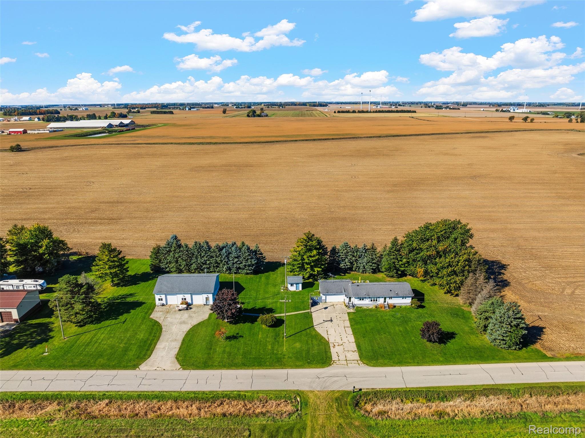 2227 North Graf Road Caro, MI 48723 - Photo 7 of 51 Expansive property featuring two structures, paved driveways, and surrounding agricultural fields