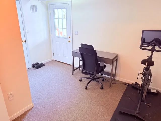 a view of workspace with wooden floor windows