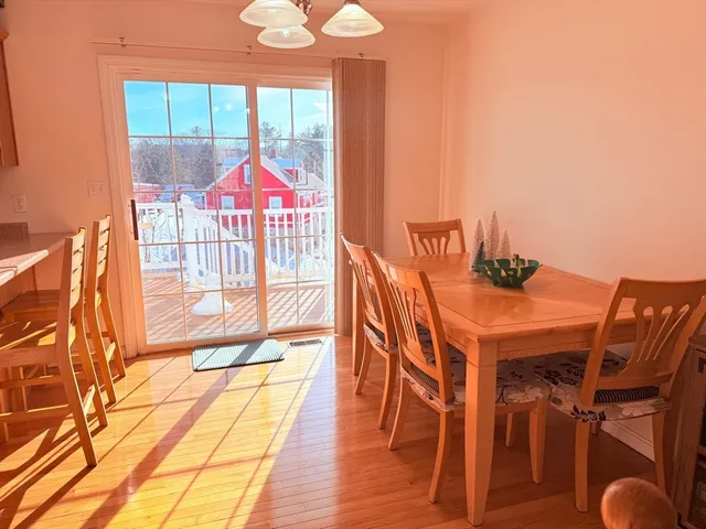 a view of a dining room with furniture wooden floor and chandelier