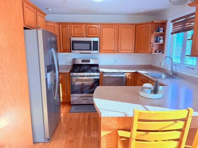 a kitchen with stainless steel appliances granite countertop a sink microwave and cabinets