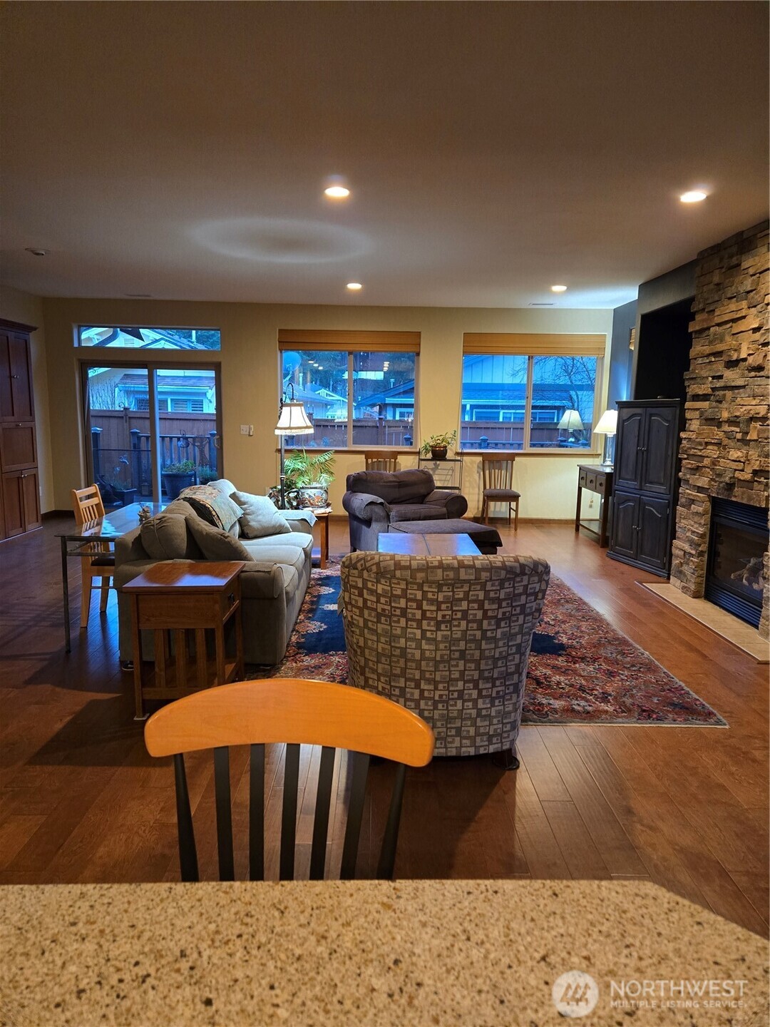 8650 Bainbridge Loop Northeast Lacey, WA 98516 - Photo 12 of 34 a living room with furniture a fireplace and a flat screen tv