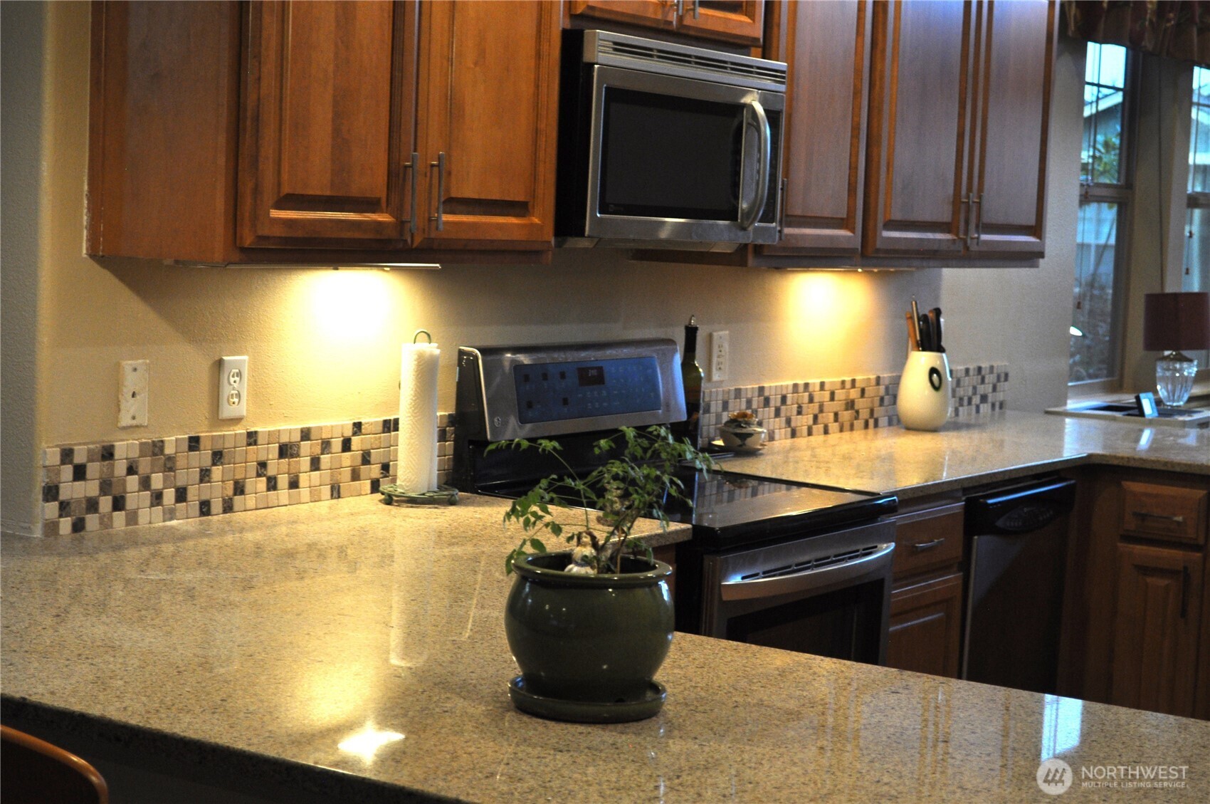 8650 Bainbridge Loop Northeast Lacey, WA 98516 - Photo 14 of 34 a kitchen with a stove and a microwave