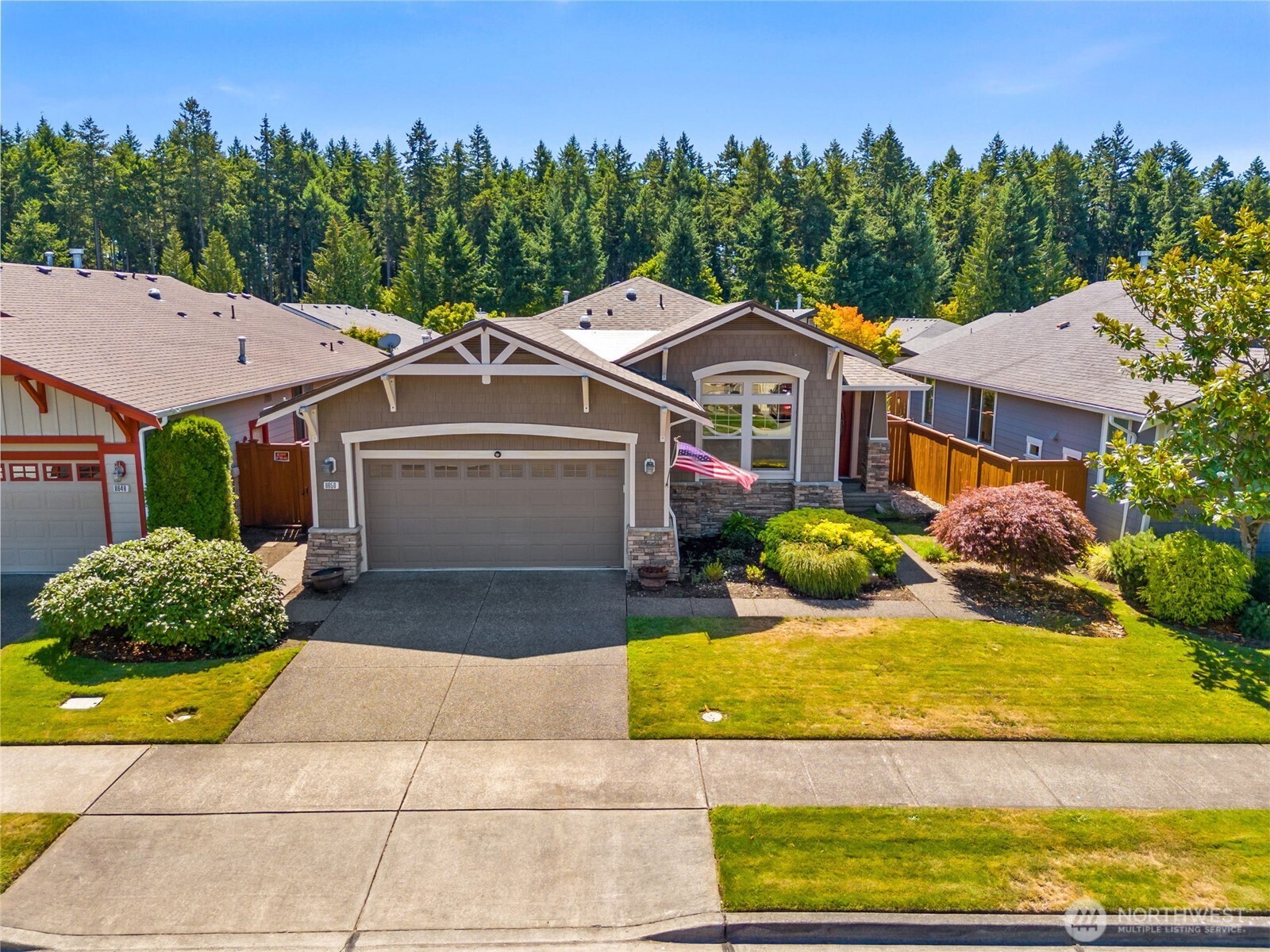 8650 Bainbridge Loop Northeast Lacey, WA 98516 - Photo 2 of 34 a front view of a house with garden