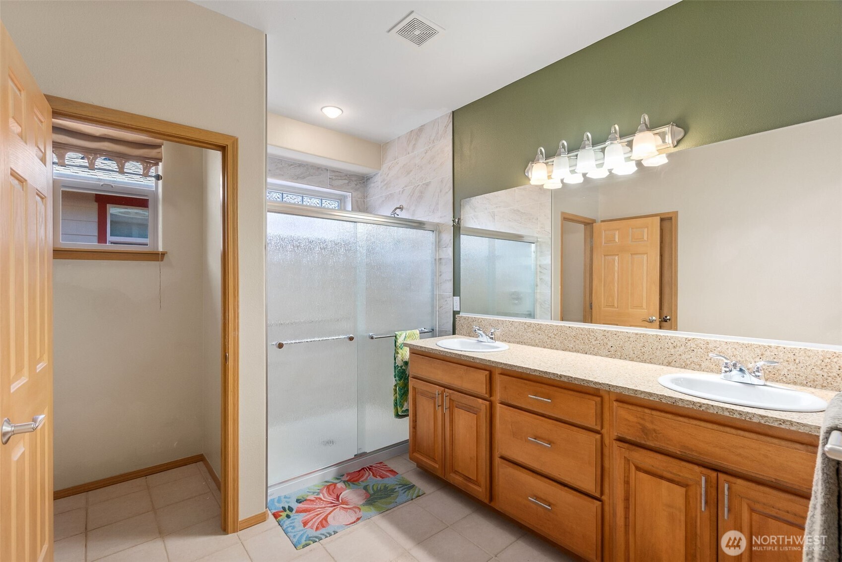 8650 Bainbridge Loop Northeast Lacey, WA 98516 - Photo 21 of 34 a spacious bathroom with a double vanity sink and a mirror