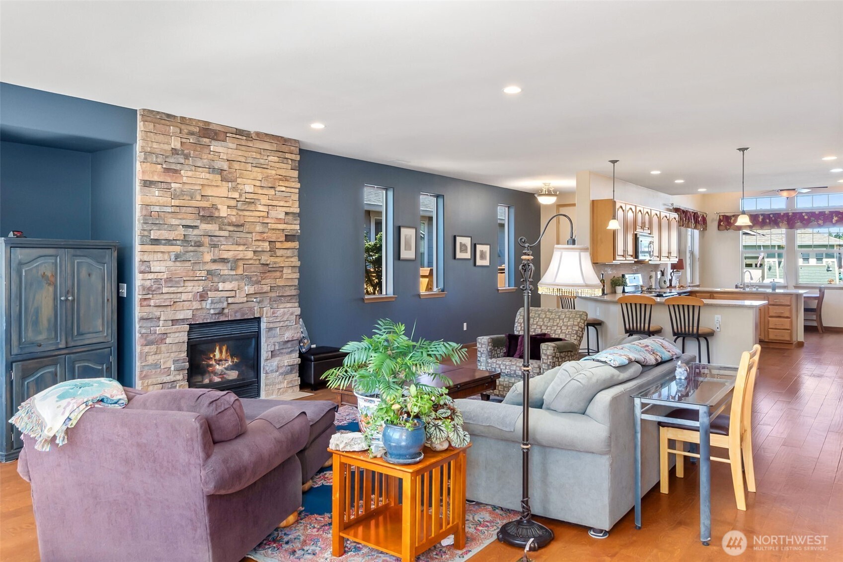 8650 Bainbridge Loop Northeast Lacey, WA 98516 - Photo 6 of 34 a living room with furniture potted plant and a fireplace