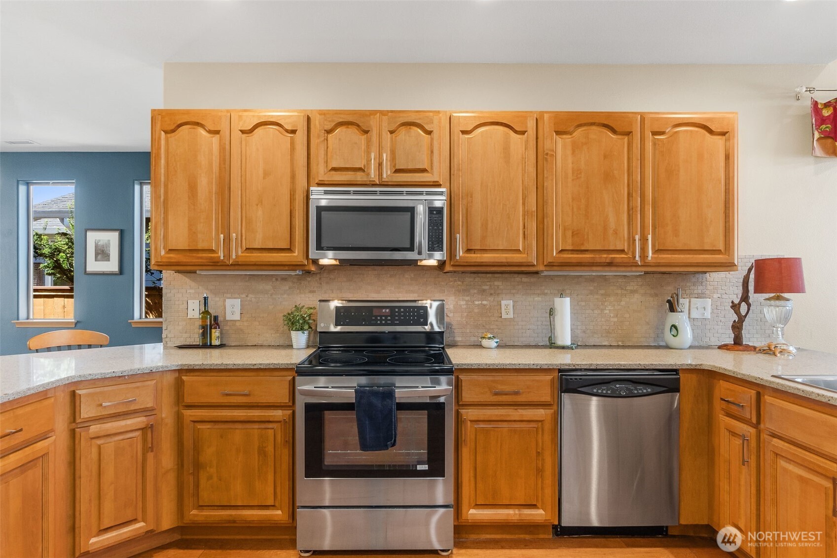 8650 Bainbridge Loop Northeast Lacey, WA 98516 - Photo 10 of 34 a kitchen with stainless steel appliances granite countertop a sink stove and microwave