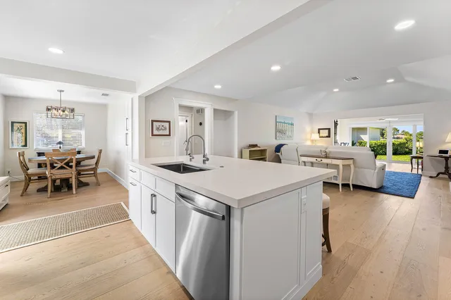 a large white kitchen with a large window