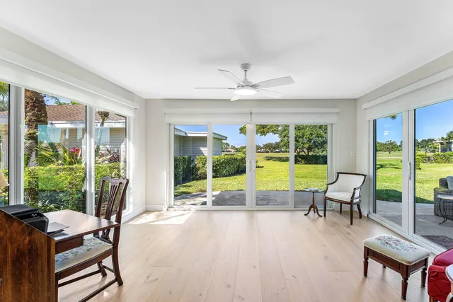 a living room filled with furniture and a large window