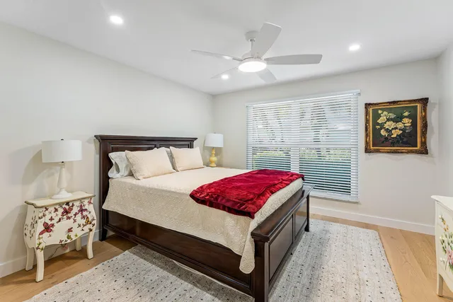 a spacious bedroom with a bed and a chandelier