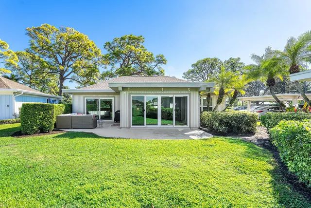 a front view of a house with a yard and outdoor seating