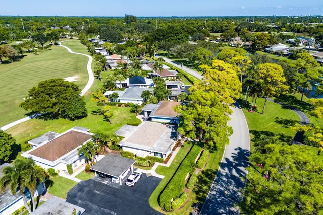an aerial view of residential houses with outdoor space and swimming pool