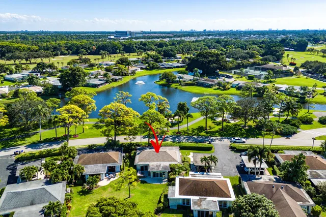 an aerial view of residential houses with outdoor space and lake view