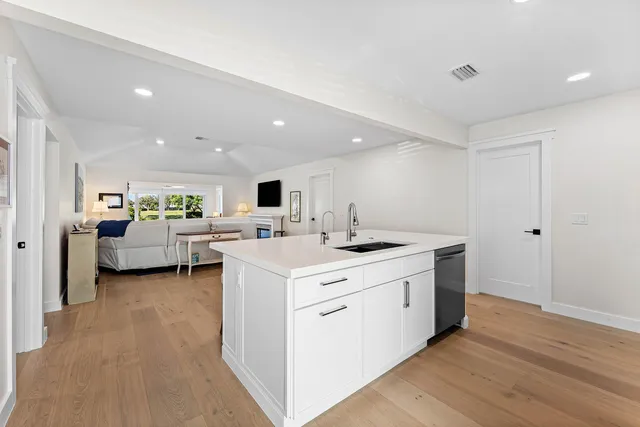a view of living room with furniture and wooden floor