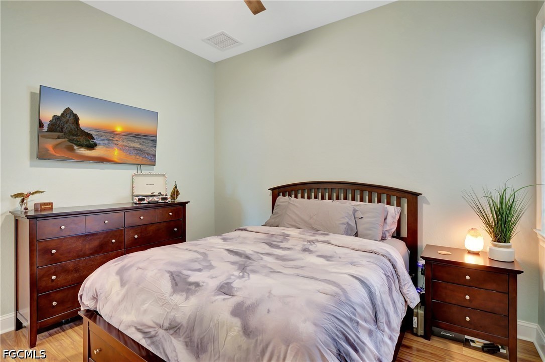 11230 Suffield Street Fort Myers, FL 33913 - Photo 20 of 42 a bedroom with a bed and a dresser