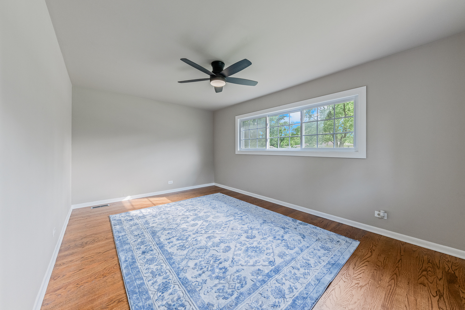 303 Springfield Street Park Forest, IL 60466 - Photo 6 of 16 a view of empty room with wooden floor and fan