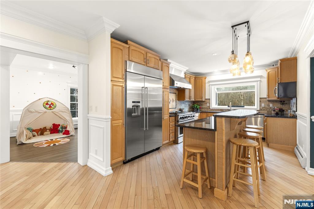 73 Big Piece Road Fairfield, NJ 07004 - Photo 12 of 45 a view of a kitchen with furniture and wooden floor