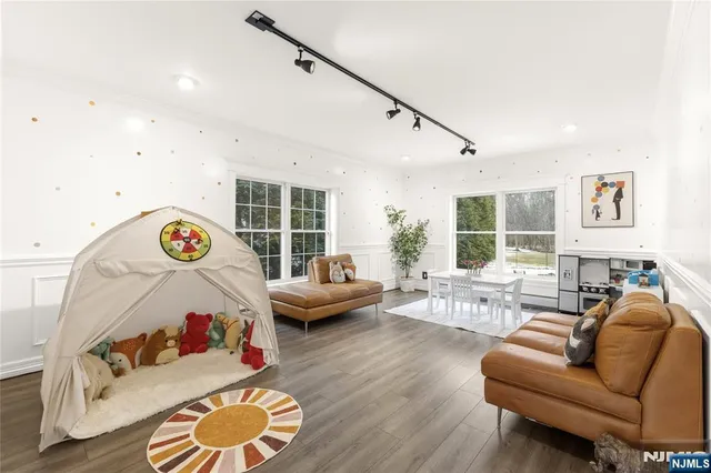 a bedroom with furniture and a large window
