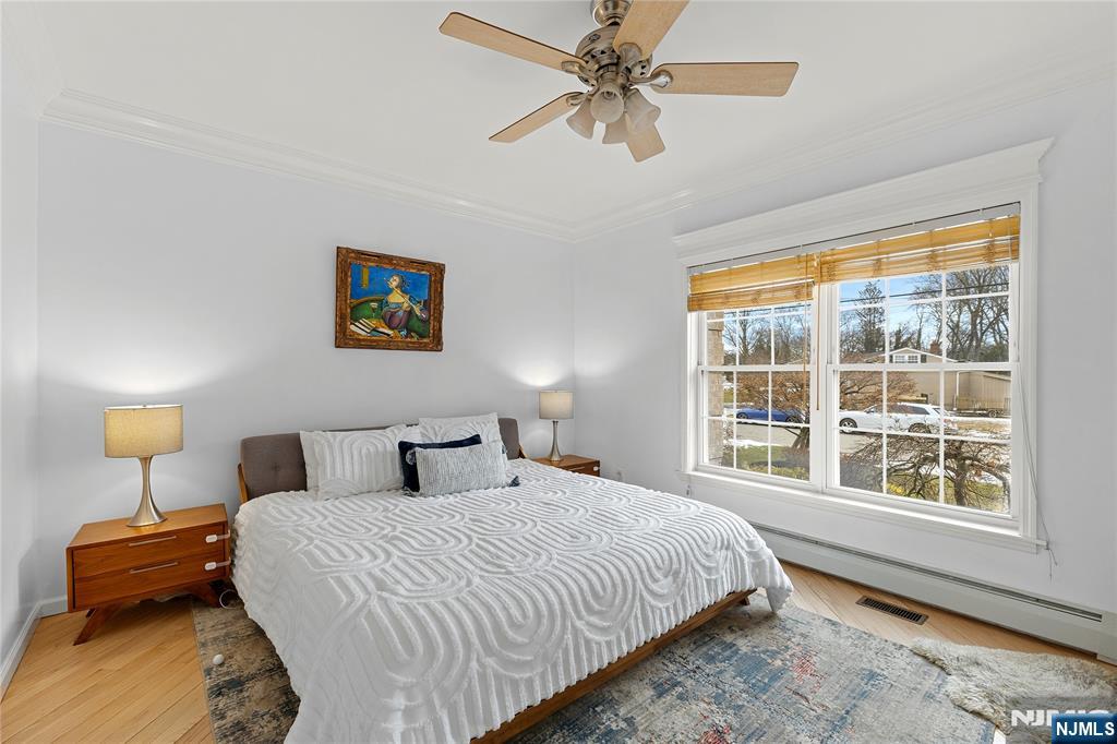 73 Big Piece Road Fairfield, NJ 07004 - Photo 15 of 45 a bedroom with a bed a window and a chandelier