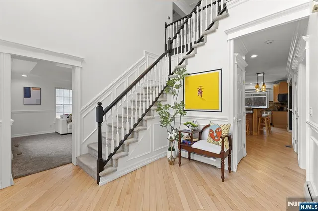 a view of a hallway with wooden floor and furniture