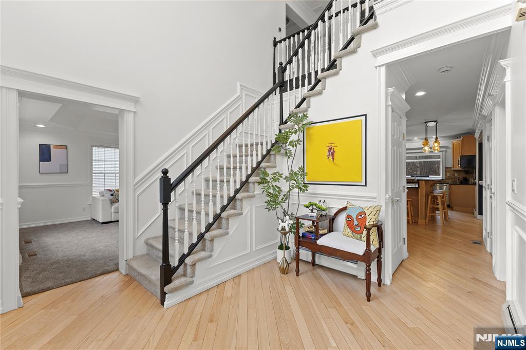 73 Big Piece Road Fairfield, NJ 07004 - Photo 18 of 45 a view of a hallway with wooden floor and furniture