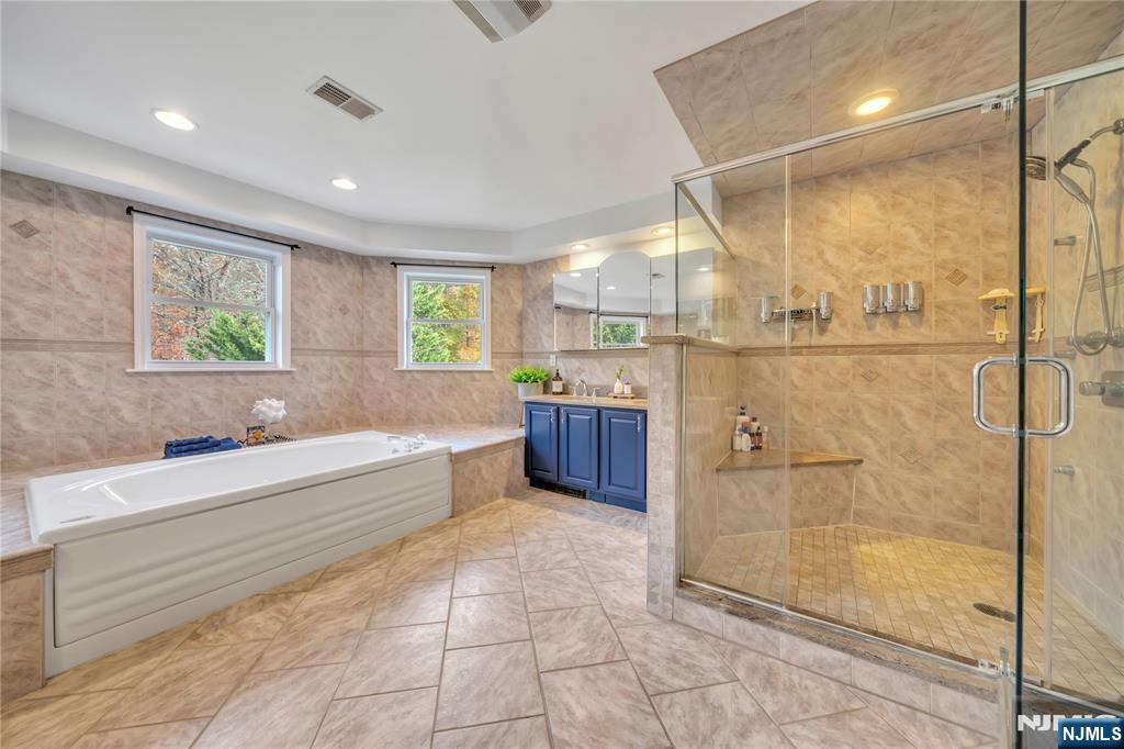 73 Big Piece Road Fairfield, NJ 07004 - Photo 21 of 45 a large bathroom with a large tub shower and sink