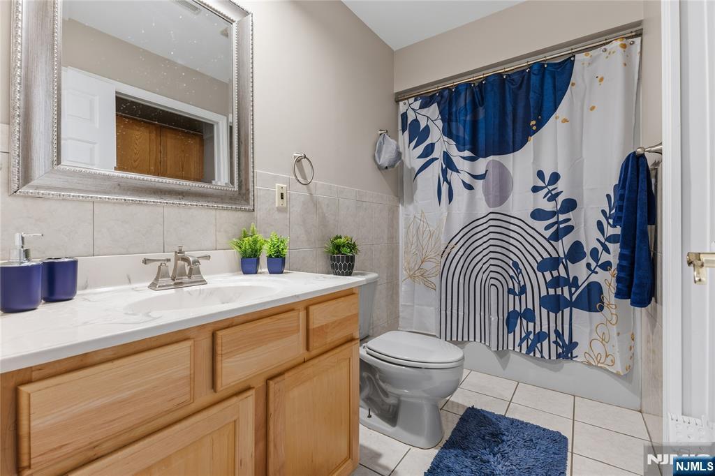 73 Big Piece Road Fairfield, NJ 07004 - Photo 26 of 45 a bathroom with a sink a toilet and a mirror