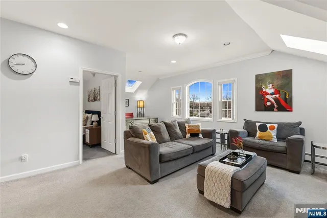 a living room with furniture ceiling fan and a window