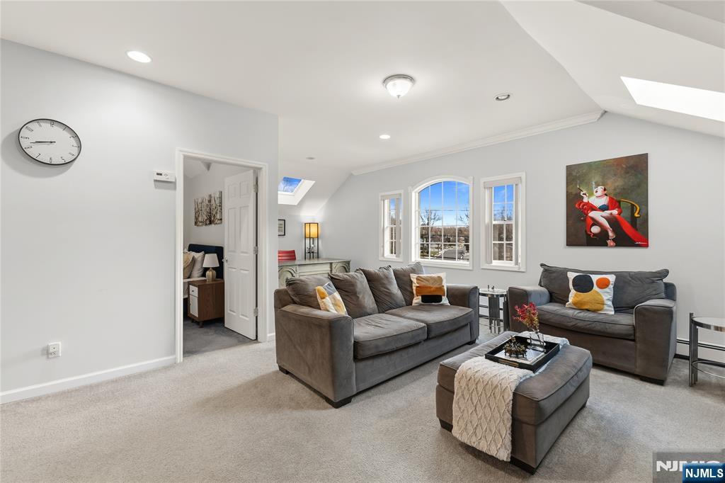 73 Big Piece Road Fairfield, NJ 07004 - Photo 29 of 45 a living room with furniture ceiling fan and a window