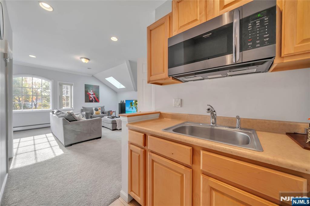 73 Big Piece Road Fairfield, NJ 07004 - Photo 30 of 45 a kitchen with a sink cabinets and microwave