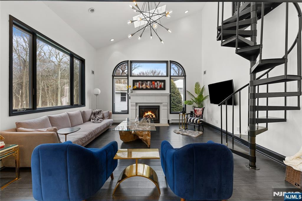 73 Big Piece Road Fairfield, NJ 07004 - Photo 3 of 45 a living room with furniture a fireplace and a flat screen tv