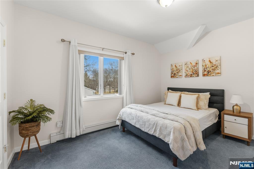 73 Big Piece Road Fairfield, NJ 07004 - Photo 32 of 45 a bedroom with a bed and a potted plant