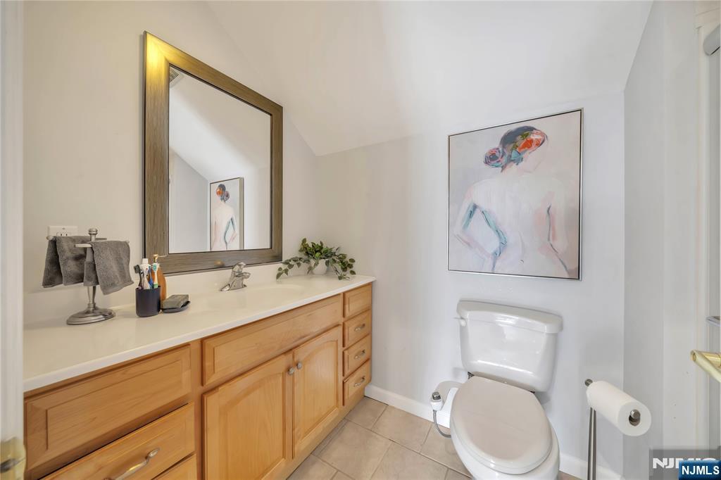 73 Big Piece Road Fairfield, NJ 07004 - Photo 33 of 45 a bathroom with a toilet a sink and mirror