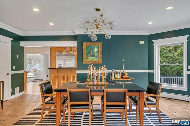 a dining room with furniture a rug and a chandelier