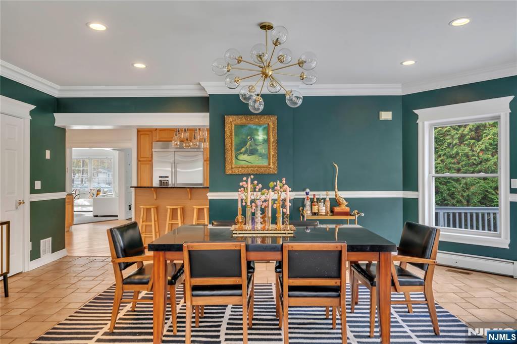 73 Big Piece Road Fairfield, NJ 07004 - Photo 6 of 45 a dining room with furniture a rug and a chandelier