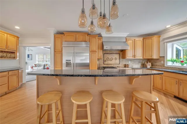a large kitchen with a table and chairs in it