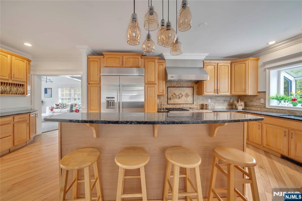 73 Big Piece Road Fairfield, NJ 07004 - Photo 7 of 45 a large kitchen with a table and chairs in it