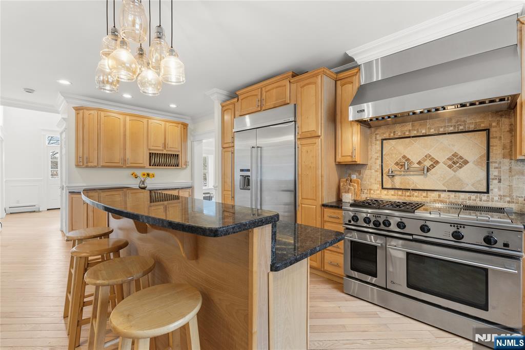 73 Big Piece Road Fairfield, NJ 07004 - Photo 8 of 45 a kitchen with stainless steel appliances a stove a sink dishwasher and cabinets with wooden floor