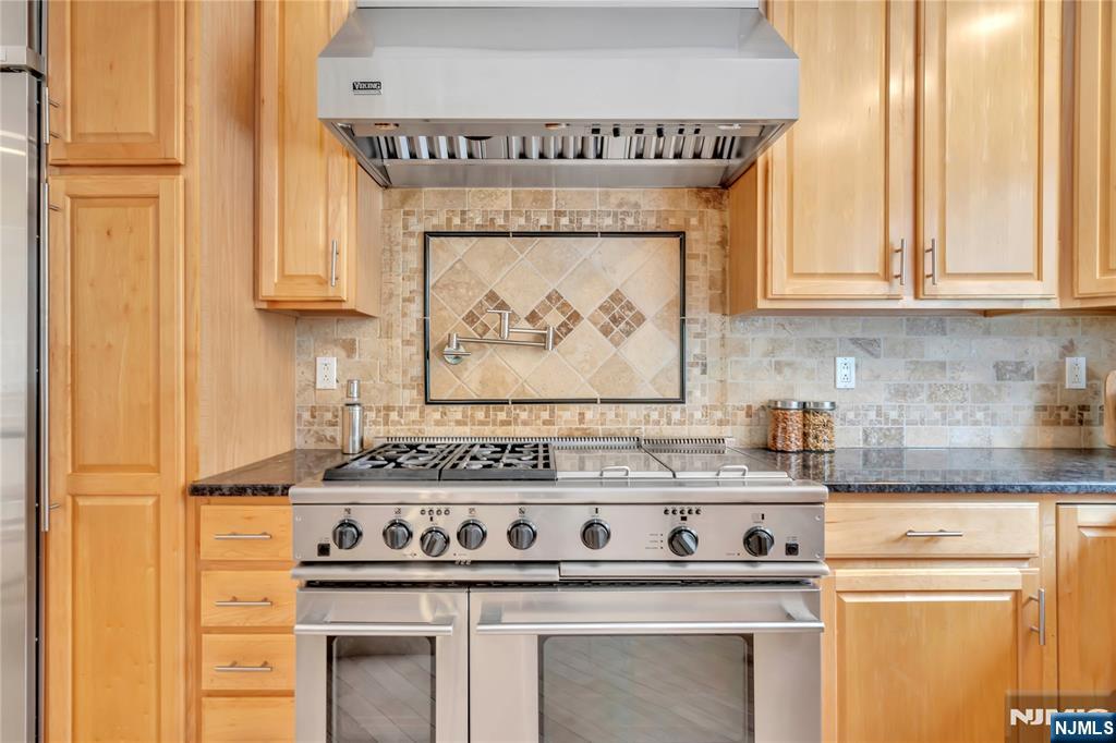 73 Big Piece Road Fairfield, NJ 07004 - Photo 10 of 45 a kitchen with a stove and a white cabinet