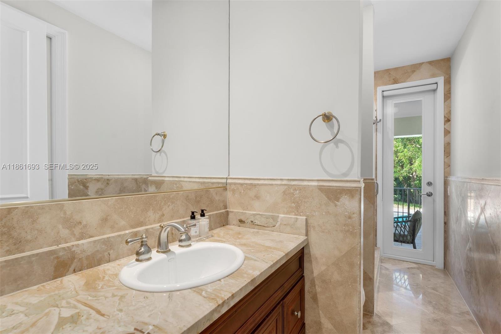 12801 Old Cutler Road Pinecrest, FL 33156 - Photo 22 of 56 a bathroom with a sink and a mirror